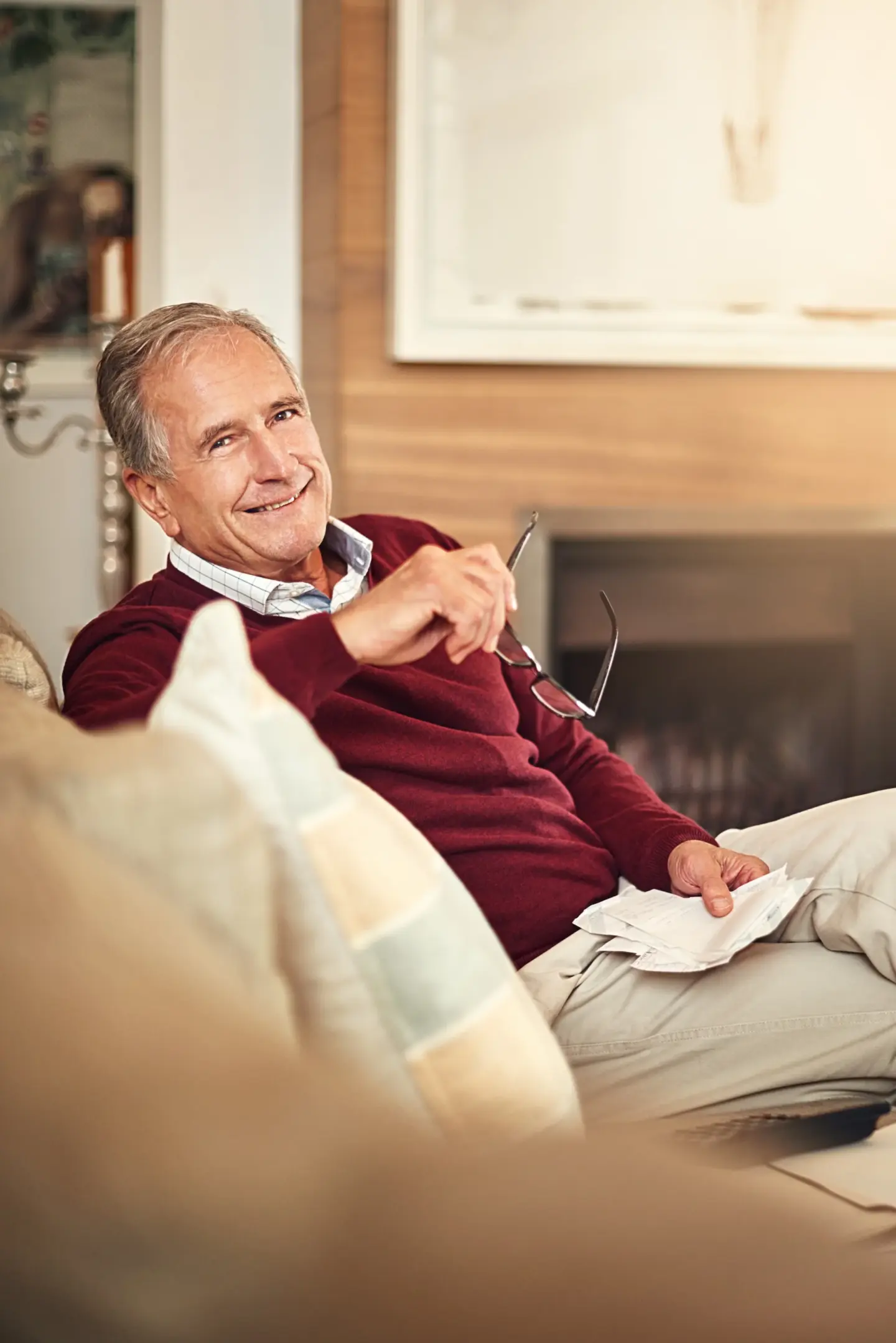 finance portrait senior man with receipts sofa expenses monthly budget pension living room accounting smile elderly person income insurance retirement plan home